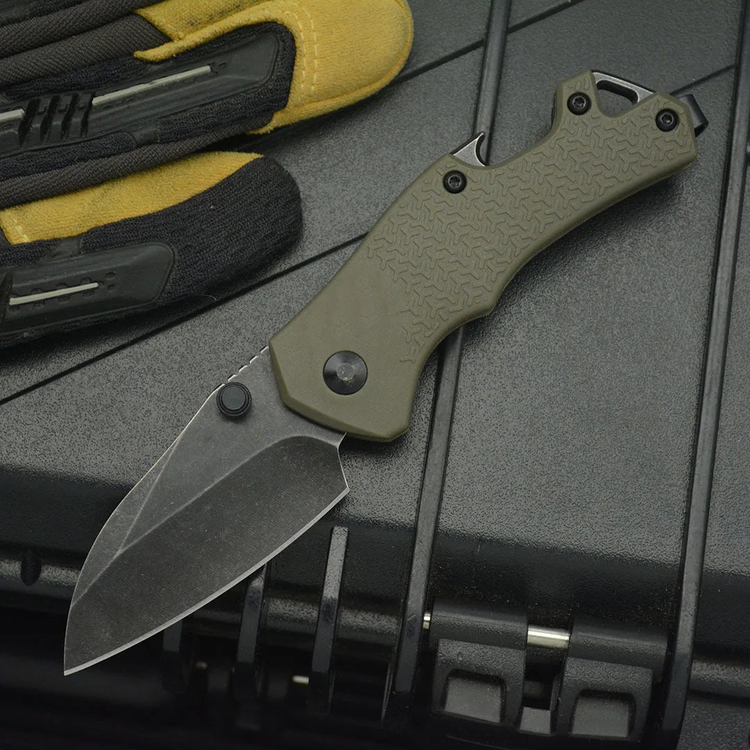 High hardness camping survival knife with a steel blade and ergonomic grip next to tactical gloves.